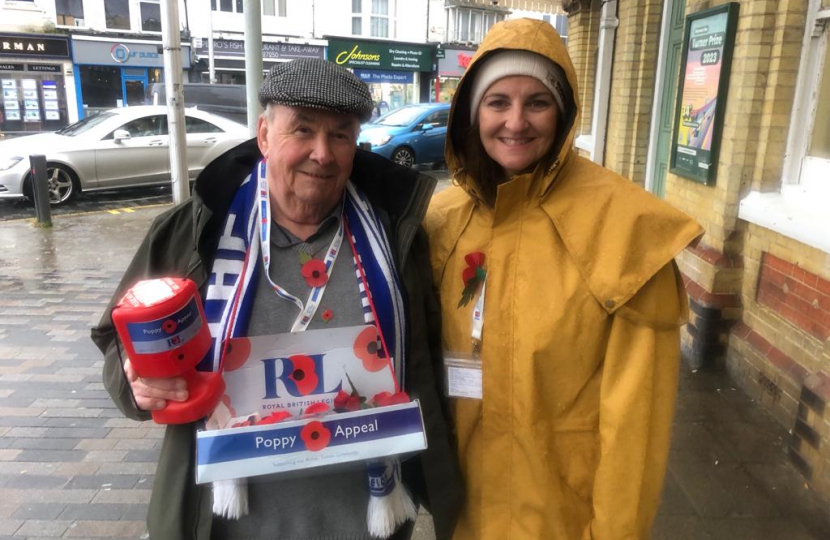 Cllr Colin and MP Caroline braving the bad weather. Selling poppies at Eastbourne Train Station. 