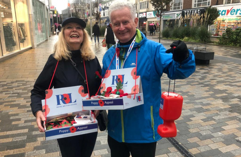 Cllr Jane and Cllr Robert braving the weather. Selling poppies in the rain. Both smiling
